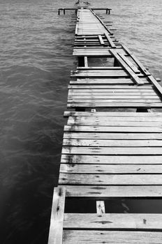 Penang island Malaysia. Wooden pier on the sea background, destroyed bridge near tropics. Black and white panorama