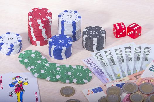 Multi-colored casino chips and money won on the game of gambling