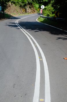 Empty road with reflectors in tropic forest. Penang island Malaysia