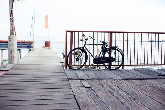 Penang, Malaysia architecture narrow streets with bicycle on wood pier. Dirty moldy humidity cityscape