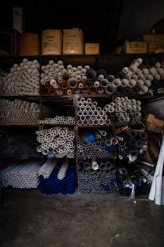 Boxes of grey and white plastic pipes in a warehouse 