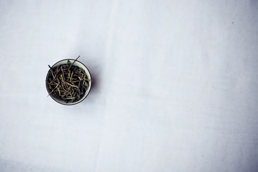 Bunch of tea puer in mug isolated on white background