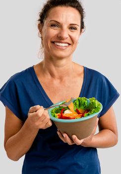 Portrait of a middle aged woman eating a healthy salade