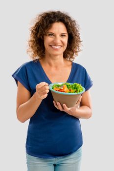 Portrait of a middle aged woman eating a healthy salade