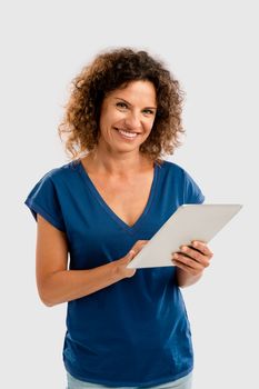 Beautiful middle aged woman working on a tablet