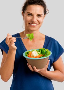 Portrait of a middle aged woman eating a healthy salade