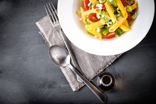 Pasta salad with fresh greenery and tomatos