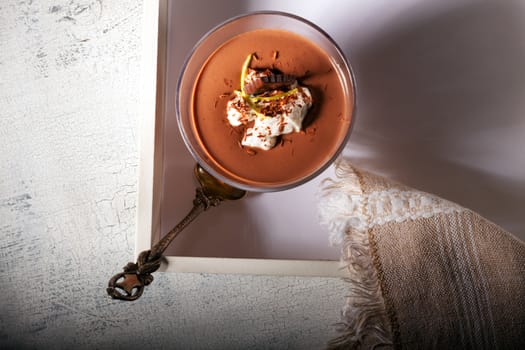 Glass with Chocolate Mousse Dessert served on a wooden surface