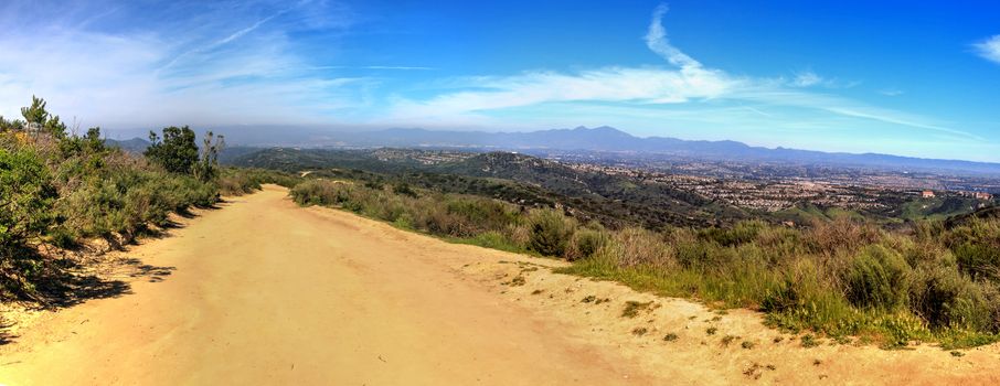 Hiking trail at the Top of the World in Laguna Beach that has a view of Saddleback Mountains and the canyon road below.