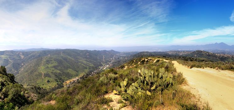 Hiking trail at the Top of the World in Laguna Beach that has a view of Saddleback Mountains and the canyon road below.