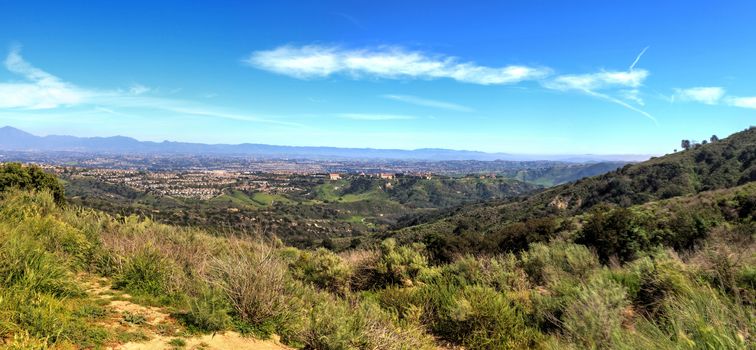 Hiking trail at the Top of the World in Laguna Beach that has a view of Saddleback Mountains and the canyon road below.