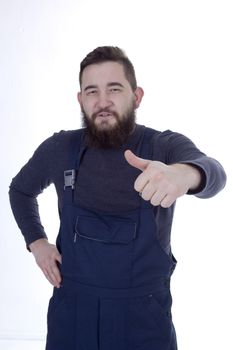 Bearded man in overall with thumb up