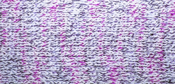 Wool scarf texture close up. Knitted jersey background with a relief pattern. Braids in machine knitting pattern