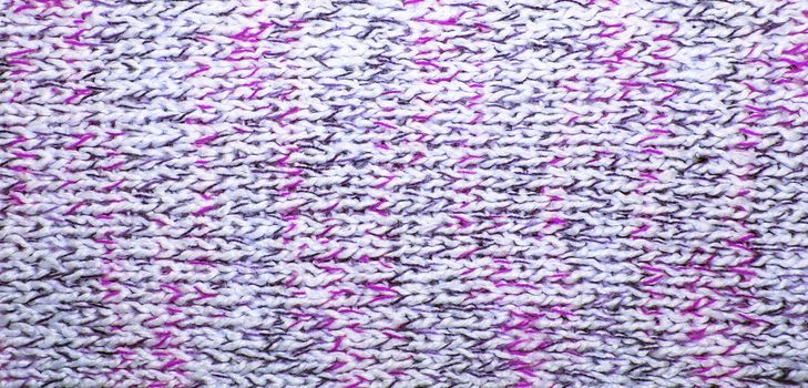 Wool scarf texture close up. Knitted jersey background with a relief pattern. Braids in machine knitting pattern