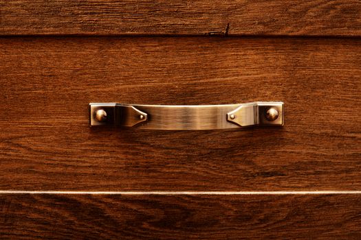 detail of decorated furniture drawers. old drawer - damper. Close-up detail of high quality Oak wood cabinets with bronze cabinet hardware drawer pulls