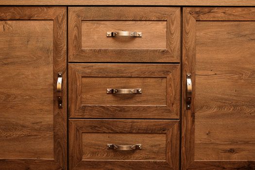 detail of decorated furniture drawers. old drawer - damper. Close-up detail of high quality Oak wood cabinets with bronze cabinet hardware drawer pulls