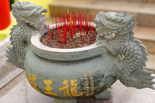 a burning Incense sticks in joss-stick pot in a chinese buddhism temple in Penang, Malaysia