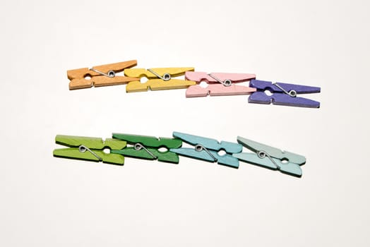 Colorful wooden clothespin. Background of colorful clothes pegs. Closeup of colorful clothespins.

