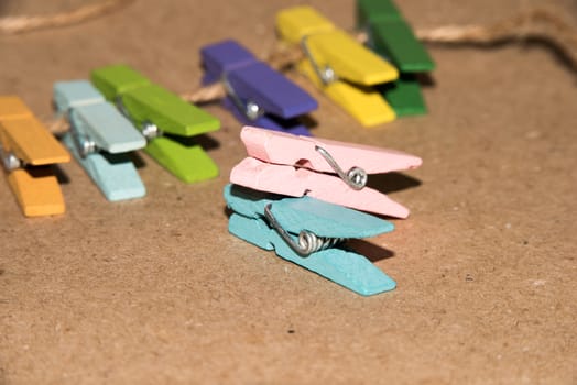 Colorful wooden clothespin. Background of colorful clothes pegs. Closeup of colorful clothespins.

