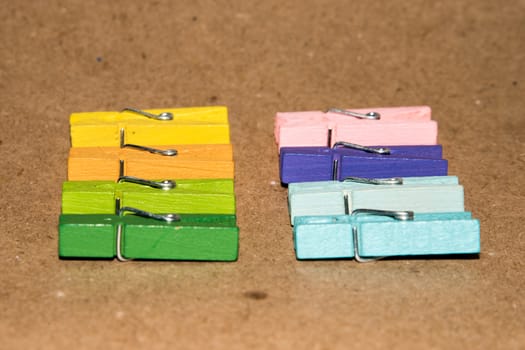 Colorful wooden clothespin. Background of colorful clothes pegs. Closeup of colorful clothespins.

