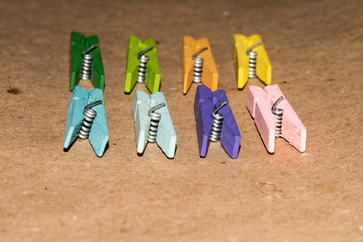 Colorful wooden clothespin. Background of colorful clothes pegs. Closeup of colorful clothespins.

