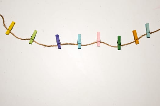 Colorful wooden clothespin. Background of colorful clothes pegs. Closeup of colorful clothespins.

