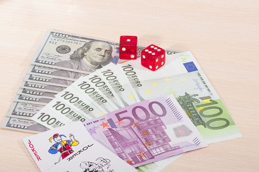 Multi-colored casino chips and money won on the game of gambling