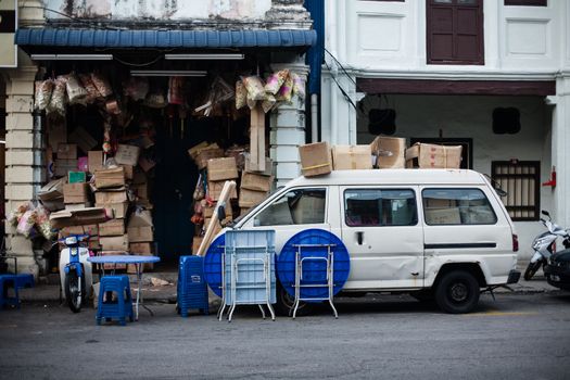 Penang, Malaysia. Color architecture narrow streets with people. Dirty moldy humidity cityscape