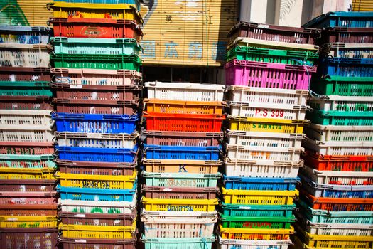 Boxes of grey and white plastic pipes in a warehouse. Storage boxes