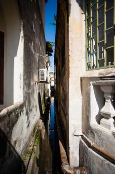 Penang, Malaysia architecture narrow streets. Dirty moldy humidity cityscape