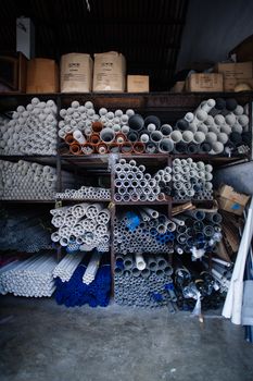 Boxes of grey and white plastic pipes in a warehouse 