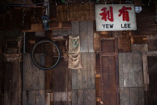 Wall with old wooden boards and boxes in garage