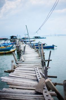 Penang island Malaysia. Wooden pier on the sea background, destroyed bridge near tropics. Color panorama