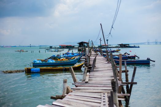 Penang island Malaysia. Wooden pier on the sea background, destroyed bridge near tropics. Color panorama