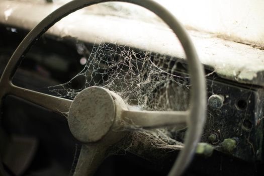 Wheel machines. Part of abandoned old car with cobwebs