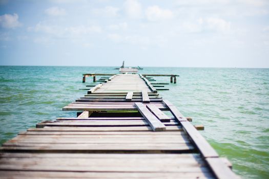 Penang island Malaysia. Wooden pier on the sea background, destroyed bridge near tropics. Color panorama