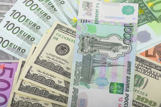 Different money bills and coins lie on the table close-up