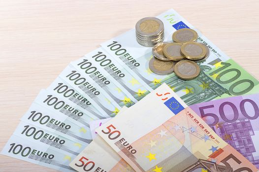 Different money bills and coins lie on the table close-up