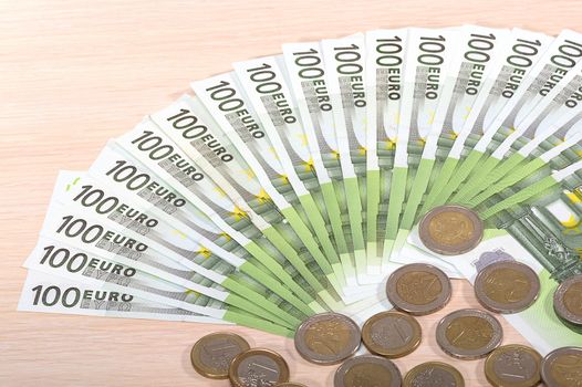 Different money bills and coins lie on the table close-up
