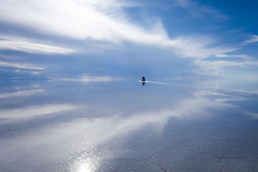 Car in Salar de Uyuni salt flats desert, Andes Altiplano, Bolivia