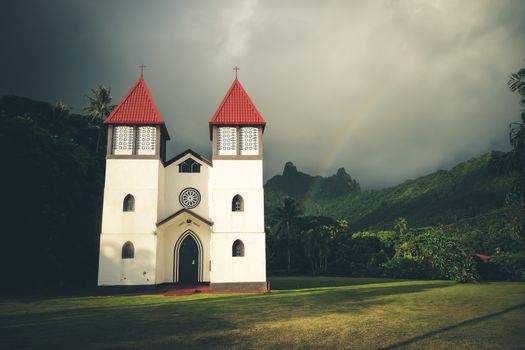 Rainbow on Haapiti church in Moorea island, landscape. French Polynesia