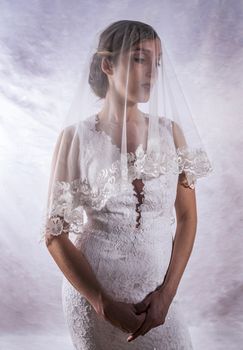 Portrait of a beautiful girl in image of the bride. Photo shot in the Studio on a white background