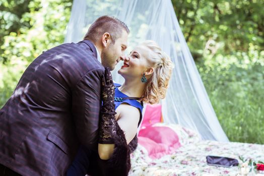 Man and woman standing by the bed and hugging on the lawn in Lviv, Ukraine.