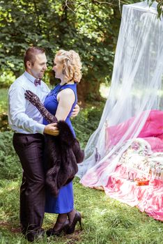 Man and woman standing by the bed and hugging on the lawn in Lviv, Ukraine.