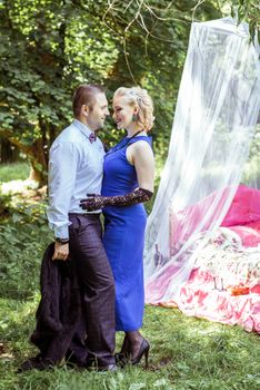 Man and woman standing by the bed and hugging on the lawn in Lviv, Ukraine.