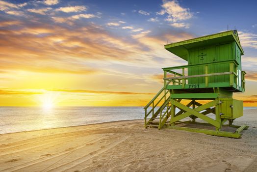 Miami South Beach sunrise with lifeguard tower and coastline with colorful cloud and blue sky. 