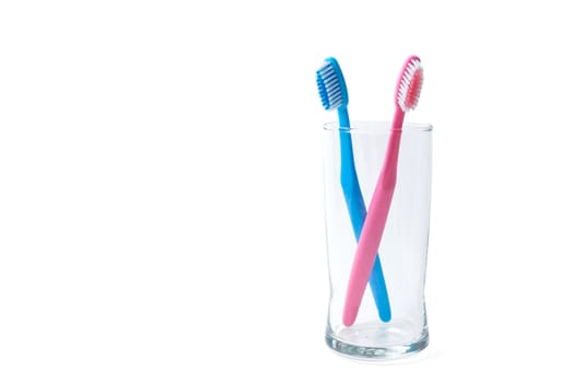 two toothbrushes in glass