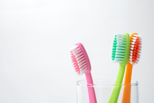 colorful toothbrushes in glass