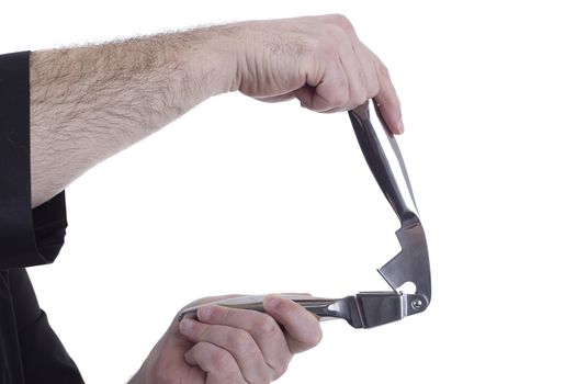 Garlic crusher in a hand on a white background