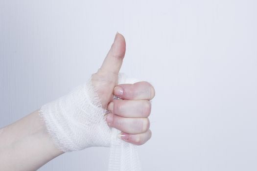 White medical dressing on a traumatized female hand